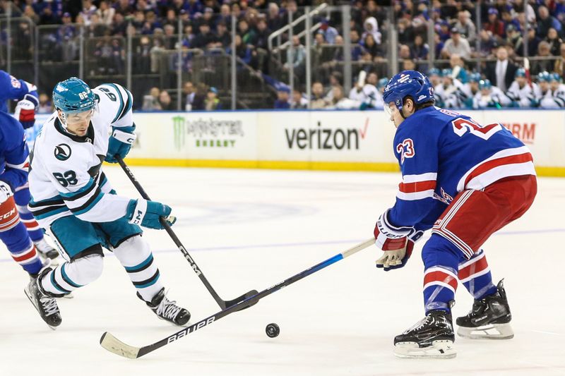 Dec 3, 2023; New York, New York, USA;  San Jose Sharks right wing Kevin Labanc (62) attempts to shoot the puck past New York Rangers defenseman Adam Fox (23) in the first period at Madison Square Garden. Mandatory Credit: Wendell Cruz-USA TODAY Sports