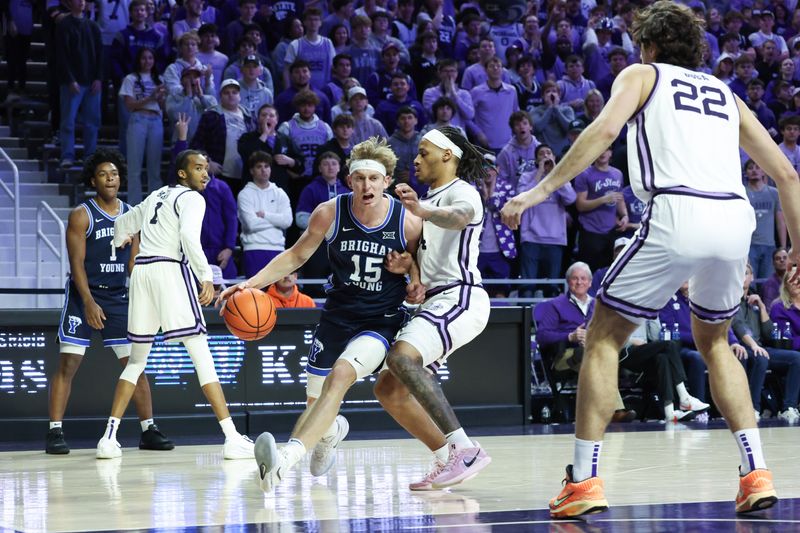 Jan 3, 2026; Manhattan, Kansas, USA; Brigham Young Cougars guard Richie Saunders (15) dribbles against Kansas State Wildcats guard Nate Johnson (34) during the first half at Bramlage Coliseum. Mandatory Credit: Scott Sewell-Imagn Images