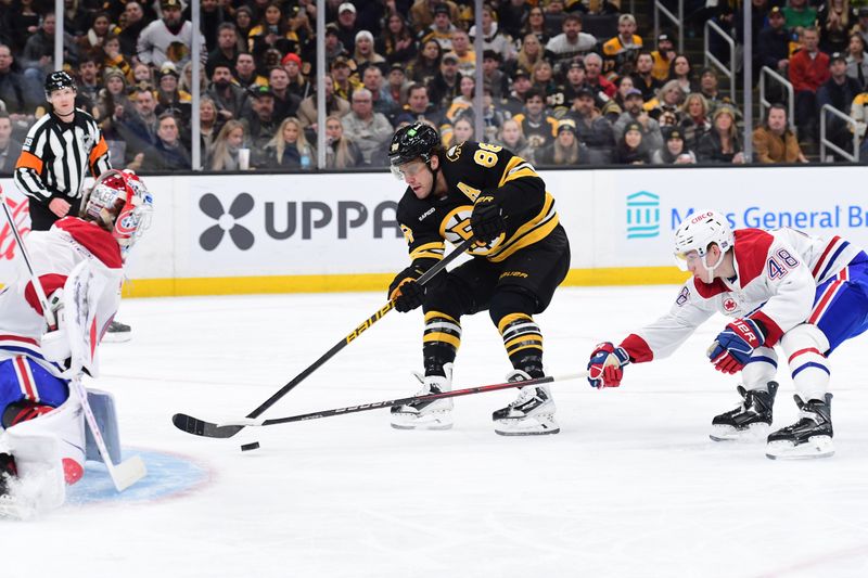 Dec 23, 2025; Boston, Massachusetts, USA;  Boston Bruins right wing David Pastrnak (88) shoots the puck towards Montreal Canadians goaltender Jacob Fowler (32) while defenseman Lane Hutson (48) defends during the first period at TD Garden. Mandatory Credit: Bob DeChiara-Imagn Images