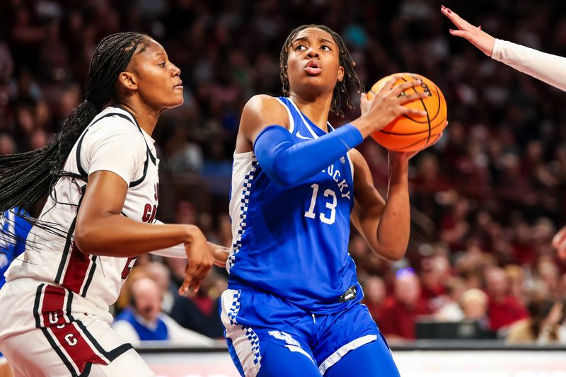 Jan 15, 2024; Columbia, South Carolina, USA; Kentucky Wildcats forward Ajae Petty (13) drives around South Carolina Gamecocks forward Sania Feagin (20) in the second half at Colonial Life Arena. Mandatory Credit: Jeff Blake-USA TODAY Sports