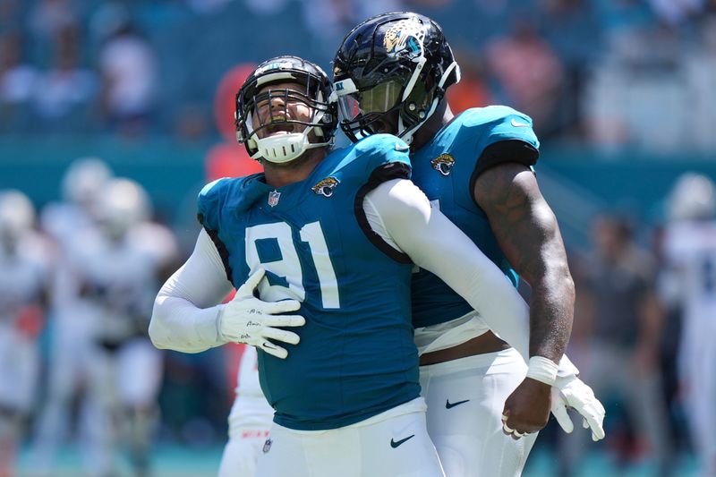 Jacksonville Jaguars defensive end Arik Armstead (91) celebrates after sacking Miami Dolphins quarterback Tua Tagovailoa during the second half of an NFL football game, Sunday, Sept. 8, 2024, in Miami Gardens, Fla. (AP Photo/Wilfredo Lee)