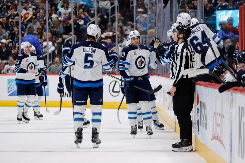 Apr 13, 2024; Denver, Colorado, USA; Winnipeg Jets center Sean Monahan (23) celebrates with teammates after his goal in the second period against the Colorado Avalanche at Ball Arena. Mandatory Credit: Isaiah J. Downing-USA TODAY Sports