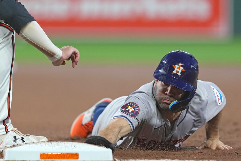 Aug 22, 2024; Baltimore, Maryland, USA; Houston Astros second baseman Jose Altuve (27) dives back safely to first base during the fourth inning against the Baltimore Orioles at Oriole Park at Camden Yards. Mandatory Credit: Mitch Stringer-USA TODAY Sports