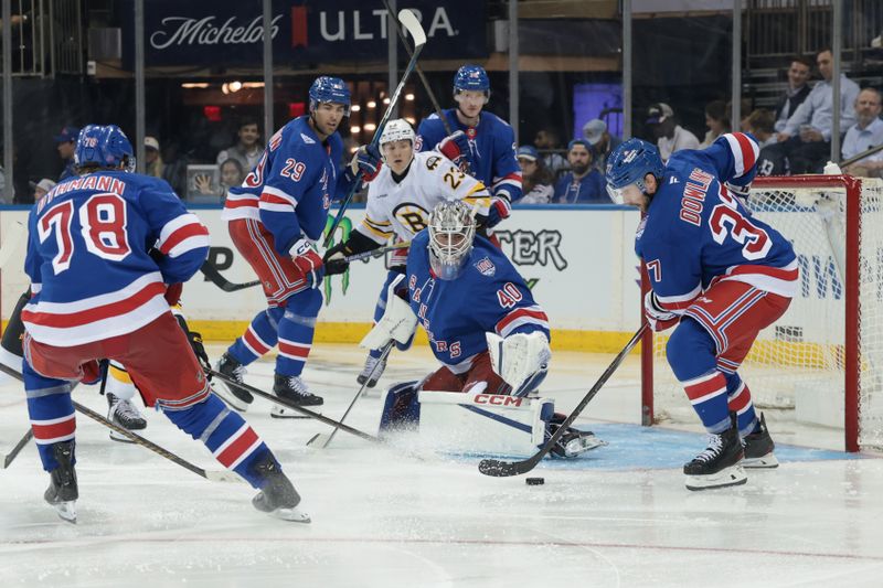 Sep 23, 2025; New York, New York, USA; New York Rangers center Justin Dowling (37) clears the puck in front of goaltender Talyn Boyko (40) during the third period of a preseason game against the Boston Bruins at Madison Square Garden. Mandatory Credit: Vincent Carchietta-Imagn Images