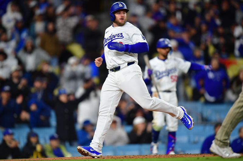 Apr 13, 2024; Los Angeles, California, USA; Los Angeles Dodgers third baseman Max Muncy (13) scores a run against the San Diego Padres during the sixth inning at Dodger Stadium. Mandatory Credit: Gary A. Vasquez-USA TODAY Sports