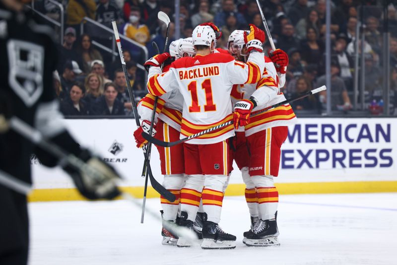 Dec 23, 2023; Los Angeles, California, USA; Calgary Flames teammates celebrate a goal by Calgary Flames defenseman Rasmus Andersson (4) during the first period against the Los Angeles Kings at Crypto.com Arena. Mandatory Credit: Jessica Alcheh-USA TODAY Sports