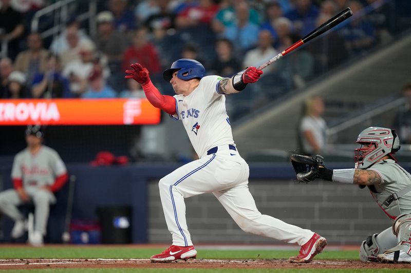 Jun 5, 2025; Toronto, Ontario, CAN; Toronto Blue Jays catcher Tyler Heineman (55) hits a one run double against the Philadelphia Phillies during the second inning at Rogers Centre. Mandatory Credit: John E. Sokolowski-Imagn Images
