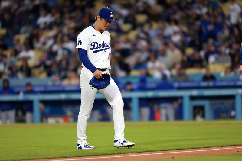 Apr 19, 2024; Los Angeles, California, USA;  Los Angeles Dodgers pitcher Yoshinobu Yamamoto (18) walks back to the dugout at the second inning against the New York Mets at Dodger Stadium. Mandatory Credit: Kiyoshi Mio-USA TODAY Sports