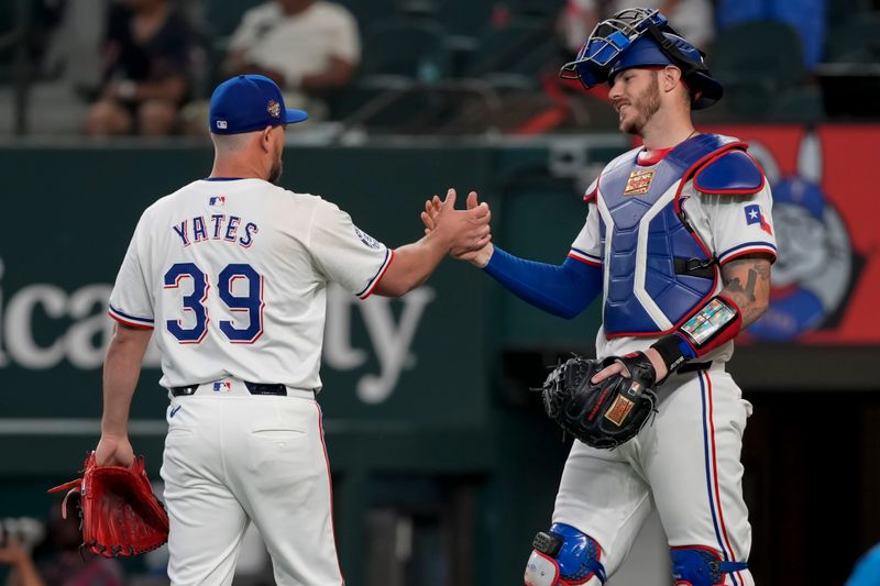 May 29, 2024; Arlington, Texas, USA; Texas Rangers relief pitcher Kirby Yates (39) and catcher Jonah Heim (28) celebrate their teams 6-1 win over the Arizona Diamondbacks following the ninth inning at Globe Life Field. Mandatory Credit: Jim Cowsert-USA TODAY Sports