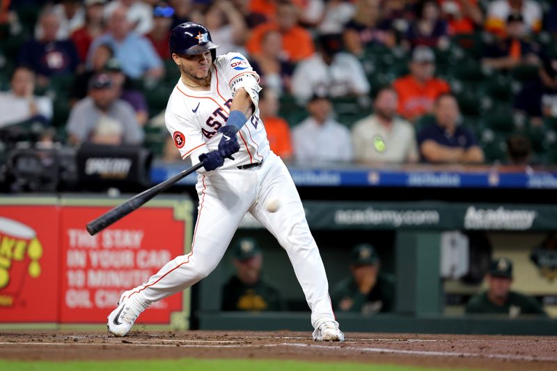 Sep 12, 2024; Houston, Texas, USA;Houston Astros catcher Yainer Diaz (21) hits a single against the Oakland Athletics during the first inning at Minute Maid Park. Mandatory Credit: Erik Williams-Imagn Images