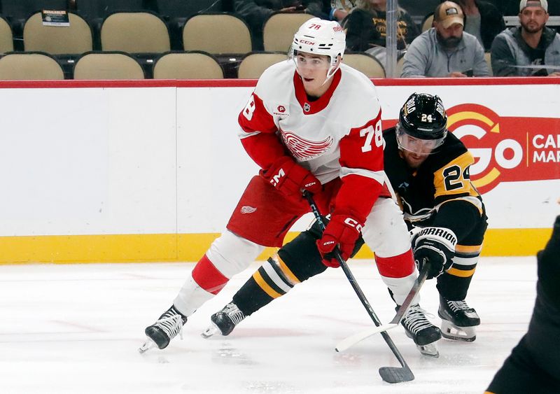 Oct 1, 2024; Pittsburgh, Pennsylvania, USA;  Detroit Red Wings center Amadeus Lombardi (78) skates in on goal against Pittsburgh Penguins defenseman Matt Grzelcyk (24) during the second period at PPG Paints Arena. Mandatory Credit: Charles LeClaire-Imagn Images