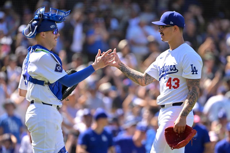 Aug 25, 2024; Los Angeles, California, USA;  Los Angeles Dodgers catcher Hunter Feduccia (67) shakes hands with relief pitcher Anthony Banda (43) after earning a save in the ninth inning against the Tampa Bay Rays at Dodger Stadium. Mandatory Credit: Jayne Kamin-Oncea-USA TODAY Sports