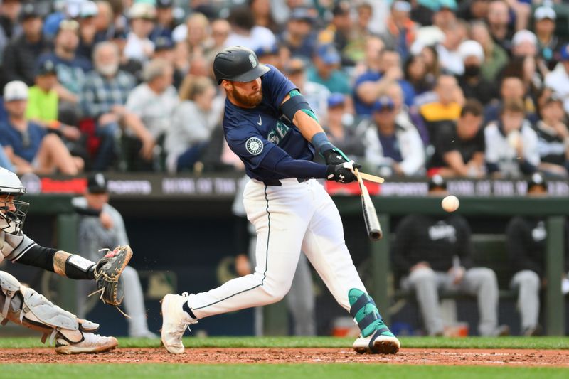 Jun 10, 2024; Seattle, Washington, USA; Seattle Mariners first baseman Tyler Locklear (27) breaks his bat hitting a single against the Chicago White Sox during the fifth inning at T-Mobile Park. Mandatory Credit: Steven Bisig-USA TODAY Sports