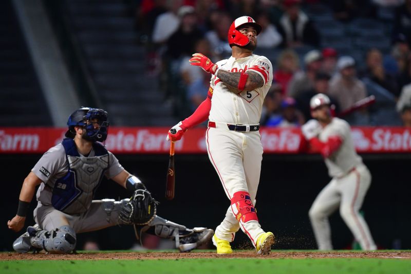 May 27, 2025; Anaheim, California, USA; Los Angeles Angels third baseman Yoan Moncada (5) hits a solo home run against the New York Yankees during the ninth inning at Angel Stadium. Mandatory Credit: Gary A. Vasquez-Imagn Images