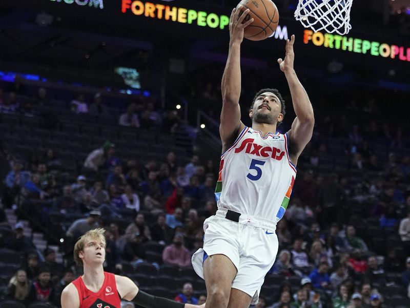 PHILADELPHIA, PENNSYLVANIA - FEBRUARY 11: Quentin Grimes #5 of the Philadelphia 76ers shoots the ball against Gradey Dick #1 of the Toronto Raptors in the second half at the Wells Fargo Center on February 11, 2025 in Philadelphia, Pennsylvania. The Raptors defeated the 76ers 106-103. NOTE TO USER: User expressly acknowledges and agrees that, by downloading and/or using this photograph, user is consenting to the terms and conditions of the Getty Images License Agreement. (Photo by Mitchell Leff/Getty Images)