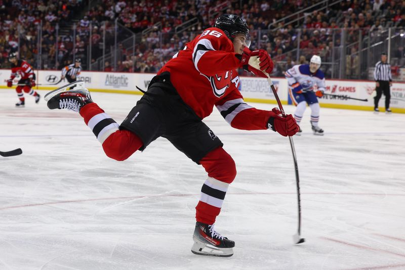 Dec 21, 2023; Newark, New Jersey, USA; New Jersey Devils center Jack Hughes (86) shoots the puck against the Edmonton Oilers during the second period at Prudential Center. Mandatory Credit: Ed Mulholland-USA TODAY Sports