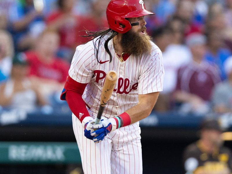 Jun 18, 2024; Philadelphia, Pennsylvania, USA; Philadelphia Phillies outfielder Brandon Marsh (16) hits an RBI single during the fourth inning against the San Diego Padres at Citizens Bank Park. Mandatory Credit: Bill Streicher-USA TODAY Sports