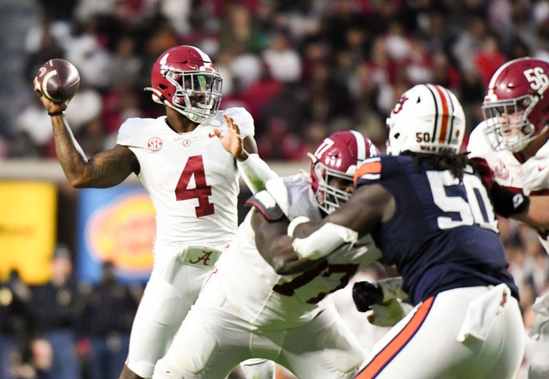 Nov 25, 2023; Auburn, Alabama, USA;  Alabama Crimson Tide quarterback Jalen Milroe (4) throws a pass against the Auburn Tigers at Jordan-Hare Stadium. Alabama won 27-24. Mandatory Credit: Gary Cosby Jr.-USA TODAY Sports