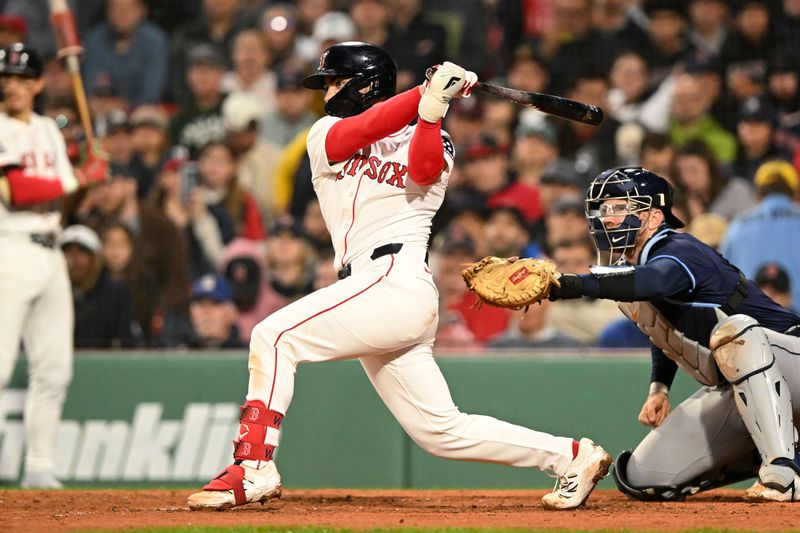 Jun 9, 2025; Boston, Massachusetts, USA; Boston Red Sox catcher Connor Wong (12) hits a RBI against the Tampa Bay Rays during the fifth inning at Fenway Park. Mandatory Credit: Brian Fluharty-Imagn Images