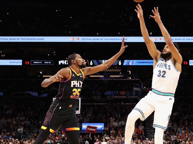 PHOENIX, ARIZONA - NOVEMBER 15: Karl-Anthony Towns #32 of the Minnesota Timberwolves attempts a shot over Kevin Durant #35 of the Phoenix Sunsduring the first half of the NBA game at Footprint Center on November 15, 2023 in Phoenix, Arizona. NOTE TO USER: User expressly acknowledges and agrees that, by downloading and or using this photograph, User is consenting to the terms and conditions of the Getty Images License Agreement.  (Photo by Christian Petersen/Getty Images)