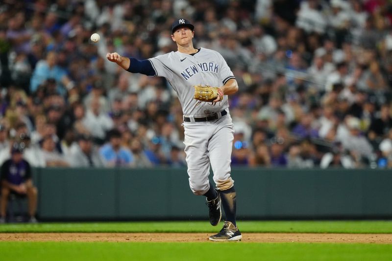 Jul 14, 2023; Denver, Colorado, USA; New York Yankees third baseman DJ LeMahieu (26) fields the ball in the seventh inning against the Colorado Rockies at Coors Field. Mandatory Credit: Ron Chenoy-USA TODAY Sports