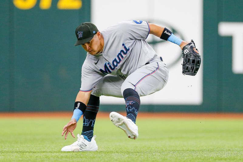 Aug 6, 2023; Arlington, Texas, USA; Miami Marlins right fielder Avisail Garcia (24) fields a ground ball during the third inning against the Texas Rangers at Globe Life Field. Mandatory Credit: Andrew Dieb-USA TODAY Sports