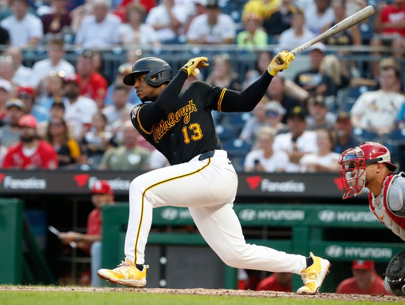 Jul 3, 2024; Pittsburgh, Pennsylvania, USA; Pittsburgh Pirates third baseman Ke'Bryan Hayes (13) drives in a run on a fielders choice groundout against the St. Louis Cardinals during the fifth inning at PNC Park. Mandatory Credit: Charles LeClaire-USA TODAY Sports