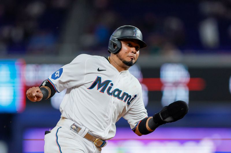 Jun 19, 2023; Miami, Florida, USA; Miami Marlins second baseman Luis Arraez (3) runs toward third base against the Toronto Blue Jays during the seventh inning at loanDepot Park. Mandatory Credit: Sam Navarro-USA TODAY Sports