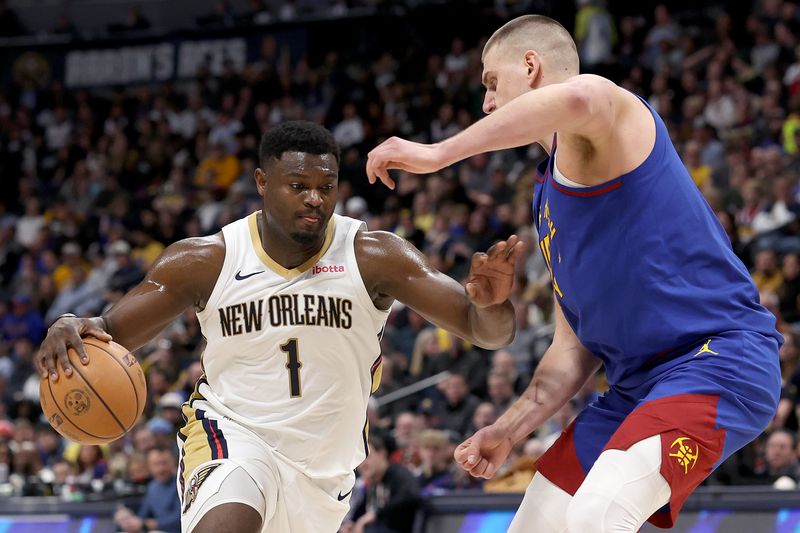 DENVER, COLORADO - JANUARY 12: Zion Williamson #1 of the New Orleans Pelicans drives against Nikola Jokic #15 of the Denver Nuggets in the fourth quarter at Ball Arena on January 12, 2024 in Denver, Colorado. NOTE TO USER: User expressly acknowledges and agrees that, by downloading and or using this photograph, User is consenting to the terms and conditions of the Getty Images License Agreement.  (Photo by Matthew Stockman/Getty Images)