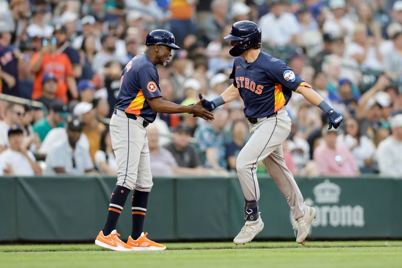 Jul 20, 2024; Seattle, Washington, USA; Houston Astros center fielder Jake Meyers (6) celebrates with third base coach Gary Pettis (8) after hitting a home run against the Seattle Mariners during the seventh inning at T-Mobile Park. Mandatory Credit: John Froschauer-USA TODAY Sports