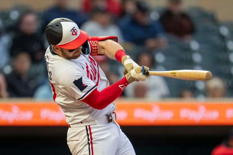 May 19, 2025; Minneapolis, Minnesota, USA; Minnesota Twins catcher Ryan Jeffers (27) hits a single against the Cleveland Guardians in the first inning at Target Field. Mandatory Credit: Jesse Johnson-Imagn Images