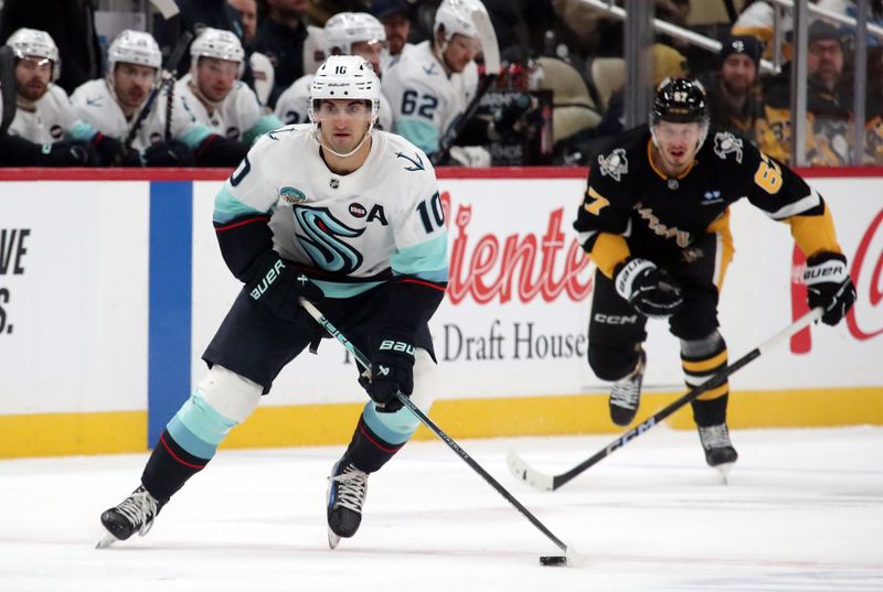 Jan 14, 2025; Pittsburgh, Pennsylvania, USA;  Seattle Kraken center Matty Beniers (10) skates spice with the puck against the Pittsburgh Penguins during the first period at PPG Paints Arena. Mandatory Credit: Charles LeClaire-Imagn Images