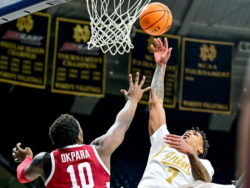 Mar 5, 2025; South Bend, Indiana, USA; Notre Dame Fighting Irish forward Tae Davis (7) is fouled by Stanford Cardinal forward Chisom Okpara (10) in the first half at the Purcell Pavilion. Mandatory Credit: Matt Cashore-Imagn Images