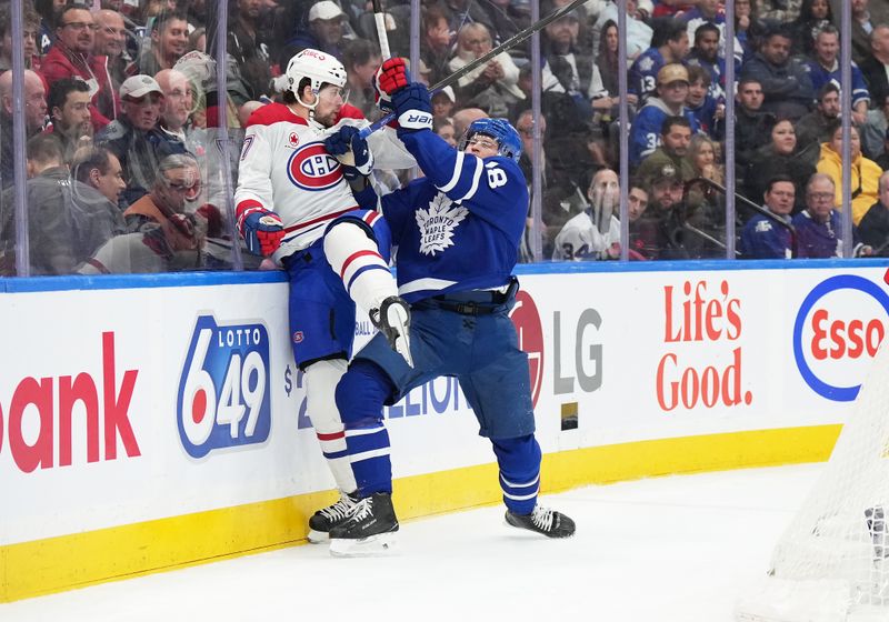 Nov 9, 2024; Toronto, Ontario, CAN; Toronto Maple Leafs center Steven Lorentz (18) battles along the boards with Montreal Canadiens right wing Josh Anderson (17) during the first period at Scotiabank Arena. Mandatory Credit: Nick Turchiaro-Imagn Images