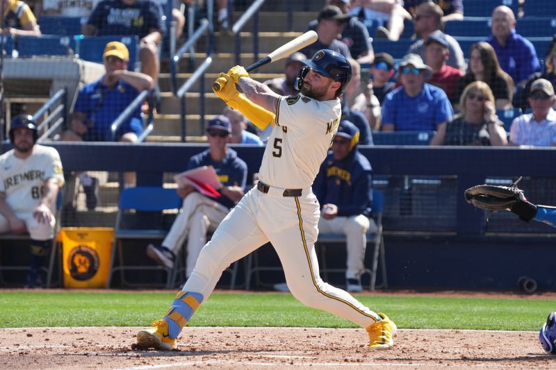Feb 26, 2025; Phoenix, Arizona, USA; Milwaukee Brewers outfielder Garrett Mitchell (5) hits a home run against the Los Angeles Dodgers during the first inning at American Family Fields of Phoenix. Mandatory Credit: Rick Scuteri-Imagn Images