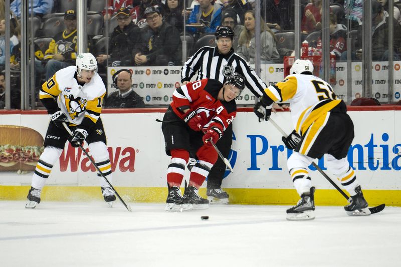 Apr 2, 2024; Newark, New Jersey, USA; New Jersey Devils left wing Ondrej Palat (18) passes the puck while being defended by Pittsburgh Penguins left wing Drew O'Connor (10) and Pittsburgh Penguins defenseman Kris Letang (58) during the second period at Prudential Center. Mandatory Credit: John Jones-USA TODAY Sports