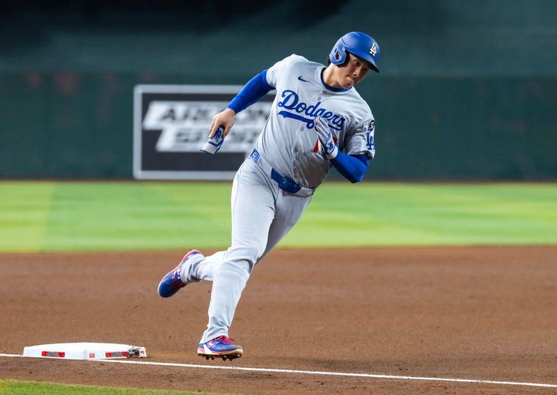 Sep 23, 2025; Phoenix, Arizona, USA; Los Angeles Dodgers pitcher/designated hitter Shohei Ohtani rounds third base to score in the sixth inning against the Arizona Diamondbacks at Chase Field. Mandatory Credit: Mark J. Rebilas-Imagn Images