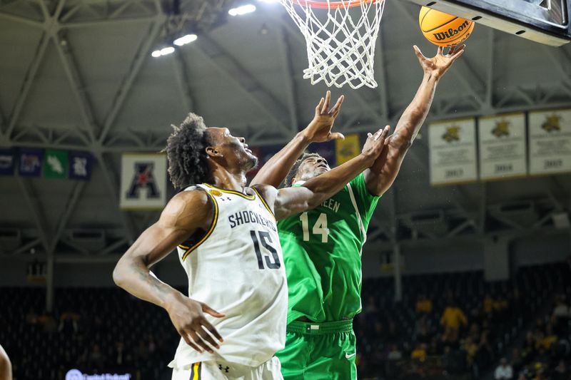 Jan 29, 2025; Wichita, Kansas, USA; North Texas Mean Green forward Moulaye Sissoko (14) shoots the ball around Wichita State Shockers center Quincy Ballard (15) during the first half at Charles Koch Arena. Mandatory Credit: William Purnell-Imagn Images