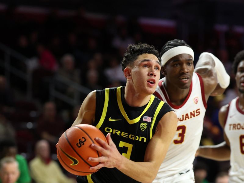 Feb 1, 2024; Los Angeles, California, USA; Oregon Ducks guard Jackson Shelstad (3) drives to the basket past USC Trojans forward Vincent Iwuchukwu (3) during the second half at Galen Center. Mandatory Credit: Kiyoshi Mio-USA TODAY Sports