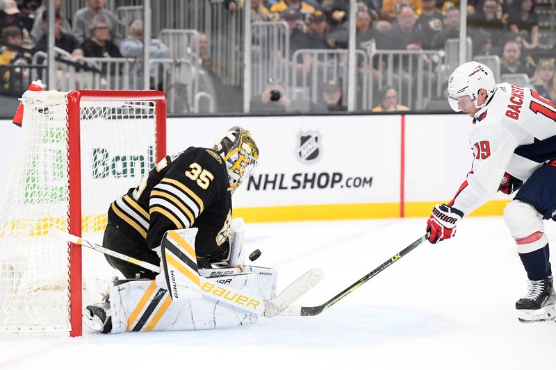 Oct 3, 2023; Boston, Massachusetts, USA;  Boston Bruins goaltender Linus Ullmark (35) blocks a shot against Washington Capitals center Nicklas Backstrom (19) during the second period at TD Garden. Mandatory Credit: Bob DeChiara-USA TODAY Sports