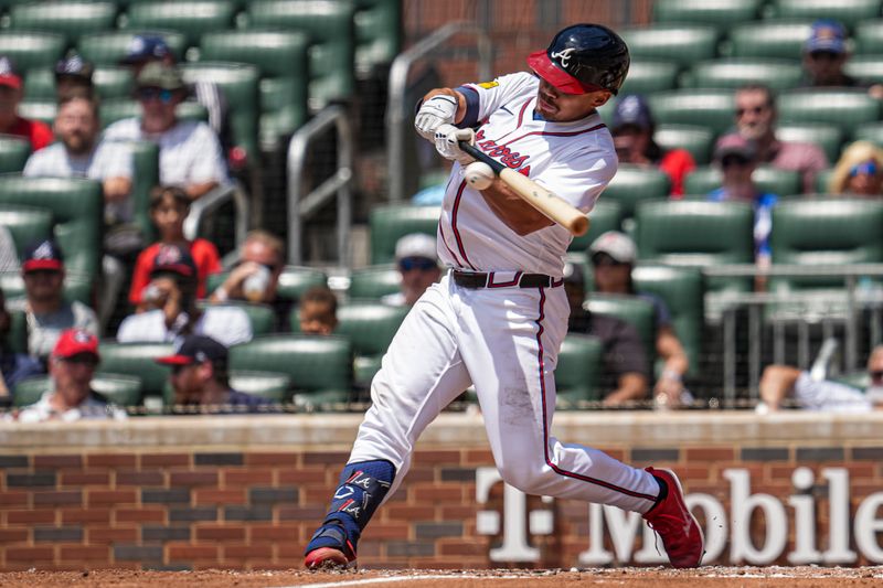May 15, 2025; Cumberland, Georgia, USA; Atlanta Braves catcher Drake Baldwin (30) singles against the Washington Nationals during the third inning at Truist Park. Mandatory Credit: Dale Zanine-Imagn Images