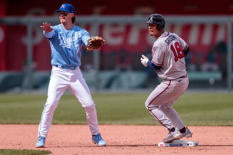 Apr 16, 2023; Kansas City, Missouri, USA; Kansas City Royals shortstop Bobby Witt Jr. (7) motions to first base as Atlanta Braves second baseman Vaughn Grissom (18) tags second base during the ninth inning at Kauffman Stadium. Mandatory Credit: William Purnell-USA TODAY Sports