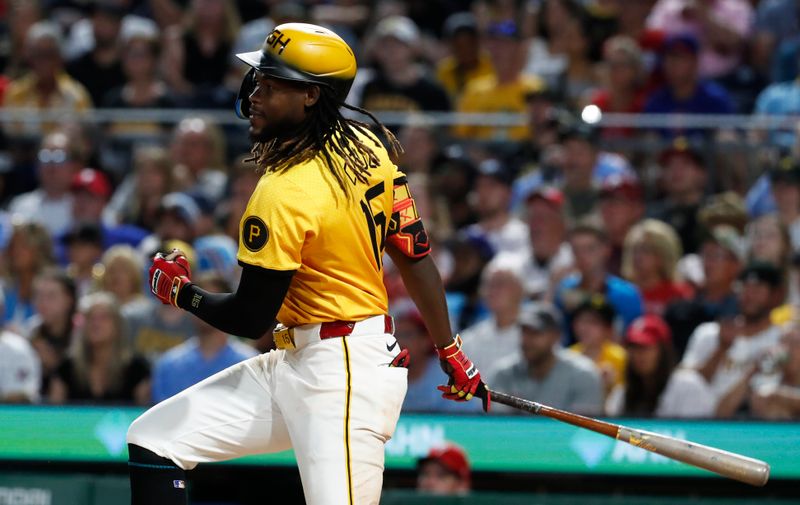 Jul 19, 2024; Pittsburgh, Pennsylvania, USA;  Pittsburgh Pirates shortstop Oneil Cruz (15) hits an RBI single against the Philadelphia Phillies during the seventh inning at PNC Park. Mandatory Credit: Charles LeClaire-USA TODAY Sports