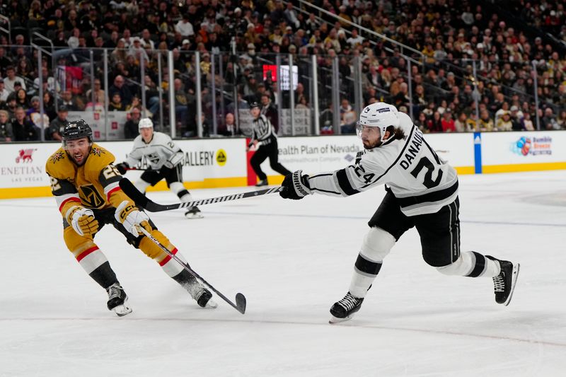 Dec 28, 2023; Las Vegas, Nevada, USA; Los Angeles Kings center Phillip Danault (24) shoots the puck against Vegas Golden Knights right wing Michael Amadio (22) during the third period at T-Mobile Arena. Mandatory Credit: Lucas Peltier-USA TODAY Sports