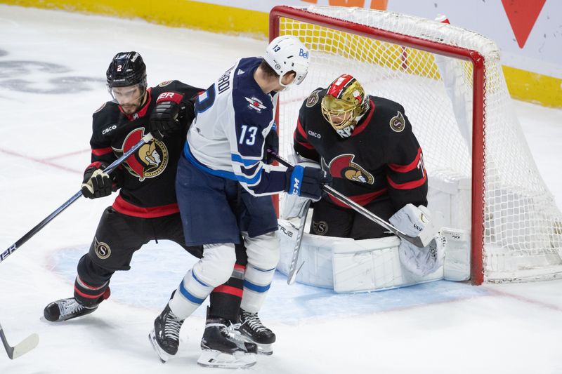 Jan 20, 2024; Ottawa, Ontario, CAN; Ottawa Senators goalie Joonas Korpisalo (70) makes a save as defenseman Artem Zub (2) defends against Winnipeg center Gabriel Vilardi (13) in the third period at the Canadian Tire Centre. Mandatory Credit: Marc DesRosiers-USA TODAY Sports