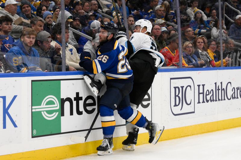 Nov 7, 2024; St. Louis, Missouri, USA; St. Louis Blues left wing Nathan Walker (26) checks Utah Hockey Club defenseman Olli Maatta (2) during the second period at Enterprise Center. Mandatory Credit: Jeff Le-Imagn Images