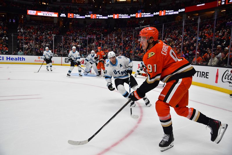 Oct 16, 2024; Anaheim, California, USA; Anaheim Ducks center Leo Carlsson (91) moves the puck against Utah Hockey Club center Nick Schmaltz (8) during the second period at Honda Center. Mandatory Credit: Gary A. Vasquez-Imagn Images