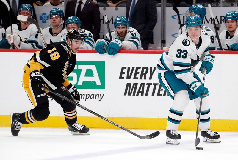 Mar 14, 2024; Pittsburgh, Pennsylvania, USA; San Jose Sharks defenseman Calen Addison (33) moves the puck against Pittsburgh Penguins right wing Reilly Smith (19) during the third period at PPG Paints Arena. Pittsburgh won 6-3. Mandatory Credit: Charles LeClaire-USA TODAY Sports