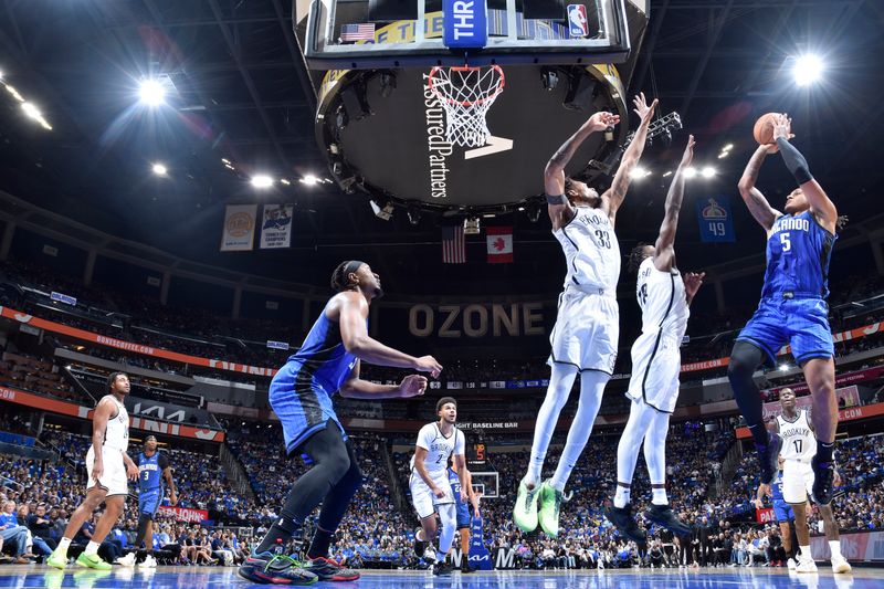 ORLANDO, FL - OCTOBER 25: Paolo Banchero #5 of the Orlando Magic shoots the ball during the game against the Brooklyn Nets on October 25, 2024 at Kia Center in Orlando, Florida. NOTE TO USER: User expressly acknowledges and agrees that, by downloading and or using this photograph, User is consenting to the terms and conditions of the Getty Images License Agreement. Mandatory Copyright Notice: Copyright 2024 NBAE (Photo by Fernando Medina/NBAE via Getty Images)