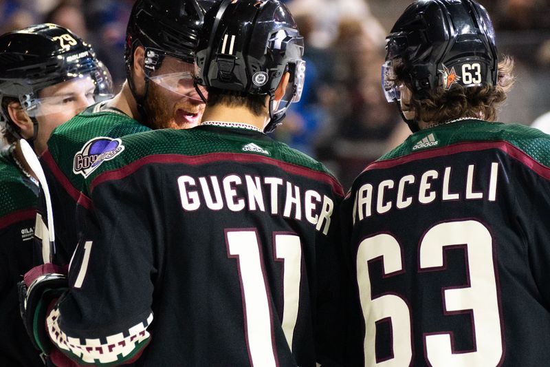 Oct 30, 2022; Tempe, Arizona, USA; Arizona Coyotes players Lawson Crouse (67) left, Dylan Guenter (11) and Matias Maccelli (63) celebrate after scoring against the New York Rangers in the second period at Mullett Arena. Mandatory Credit: Allan Henry-USA TODAY Sports